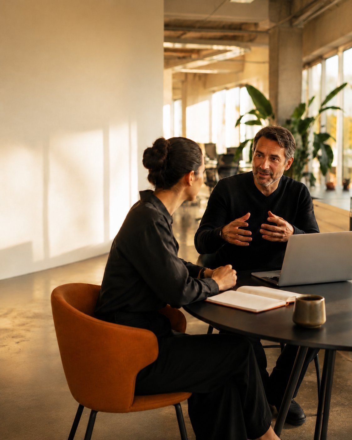 Two professionals in conversation in a bright, modern office